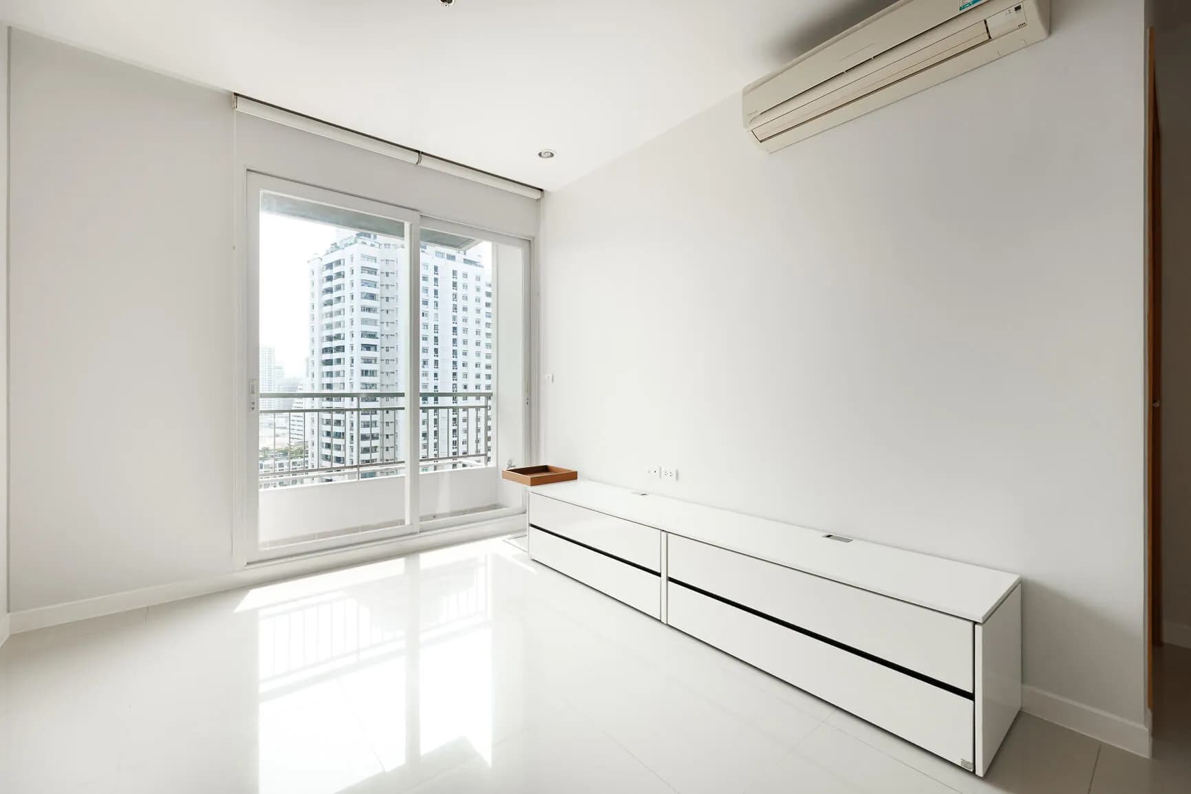 Circle Condominium interior with long built-in media console and city view