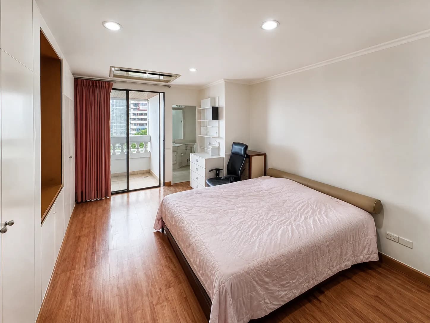 Main bedroom with balcony access in The Regency unit