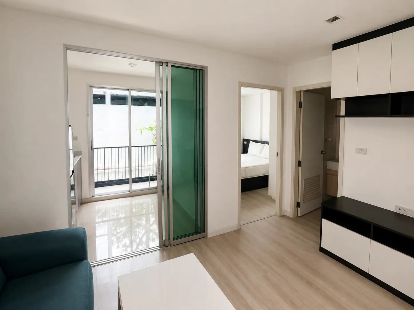 Living area and balcony access in the Metro Luxe Rama 4 unit