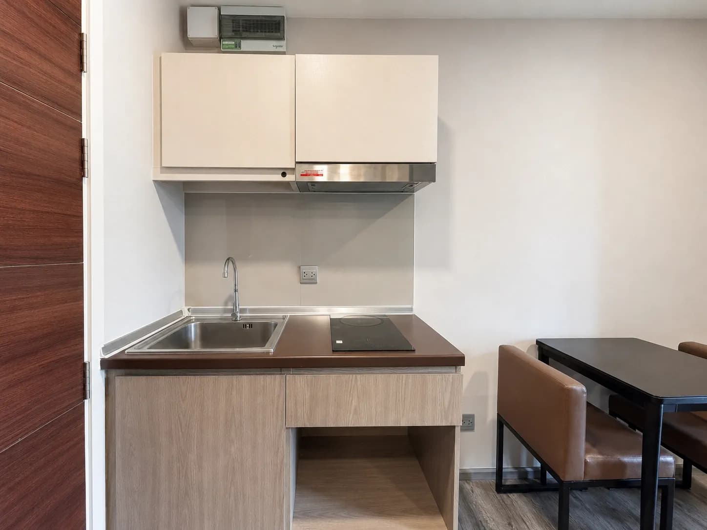 Compact kitchen and dining nook in the Brown Condo unit