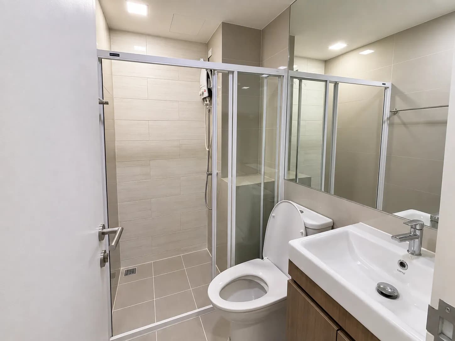 Bathroom with glass shower enclosure in the Brown Condo unit
