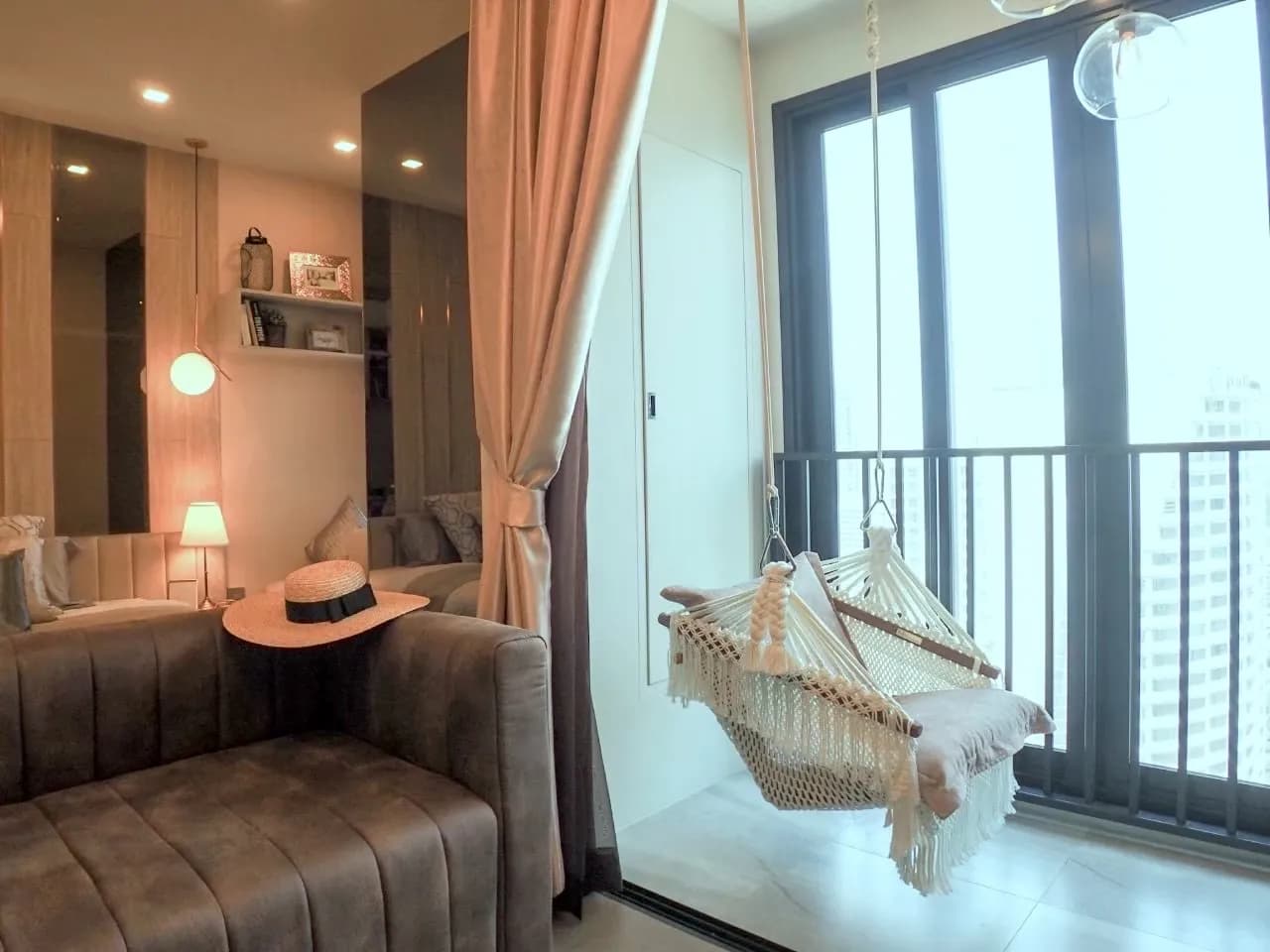 Living area with a hanging chair by the window