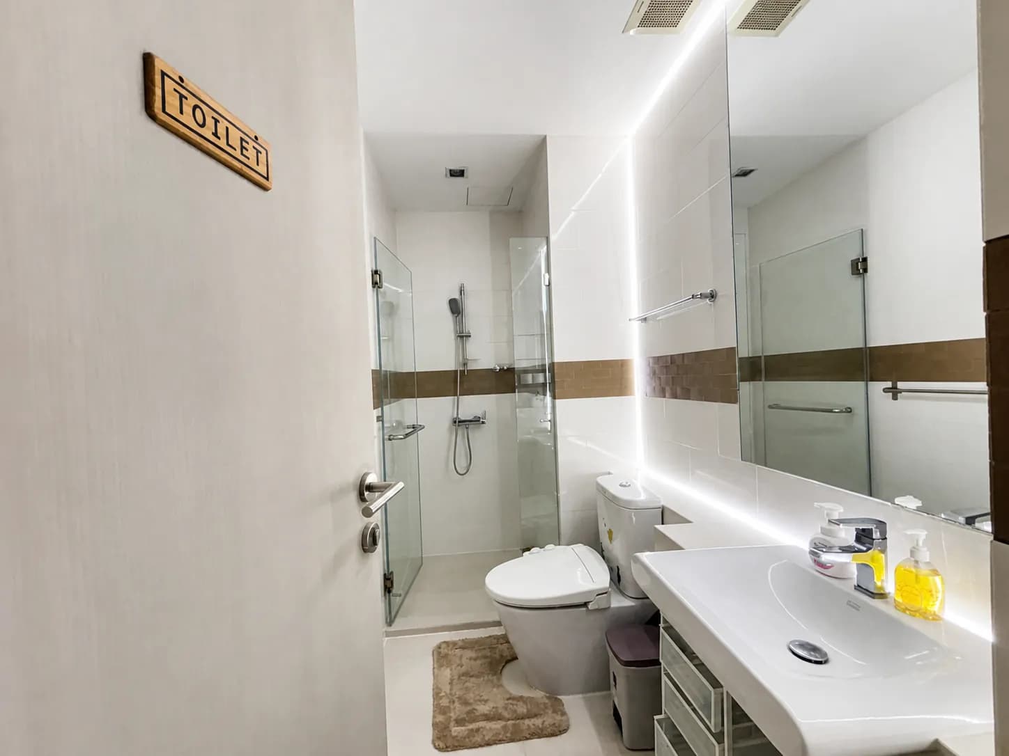 Bathroom with glass shower enclosure in the Ideo Verve Sukhumvit unit