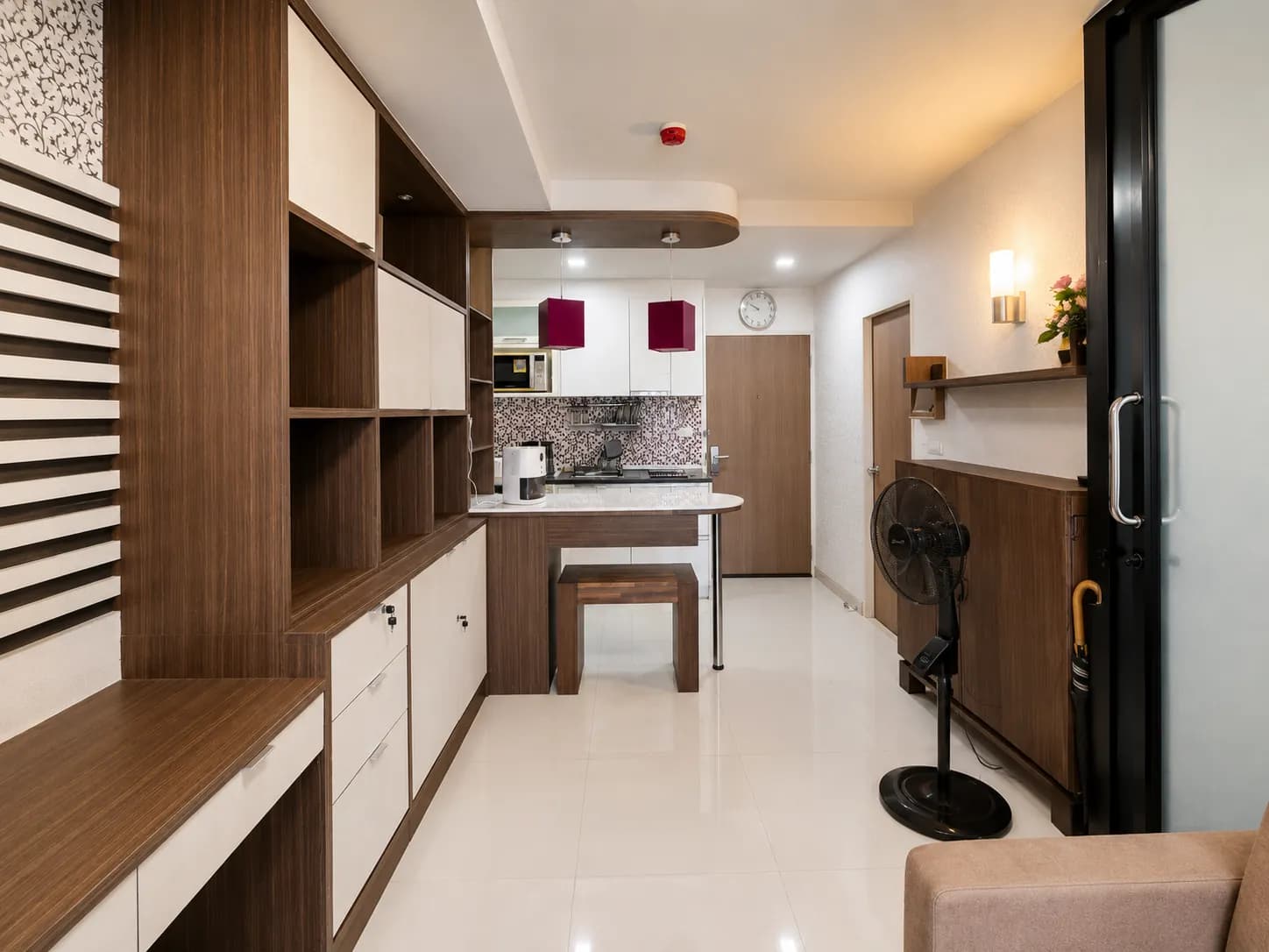 Compact fitted kitchen with cabinets, sink, and cooking area