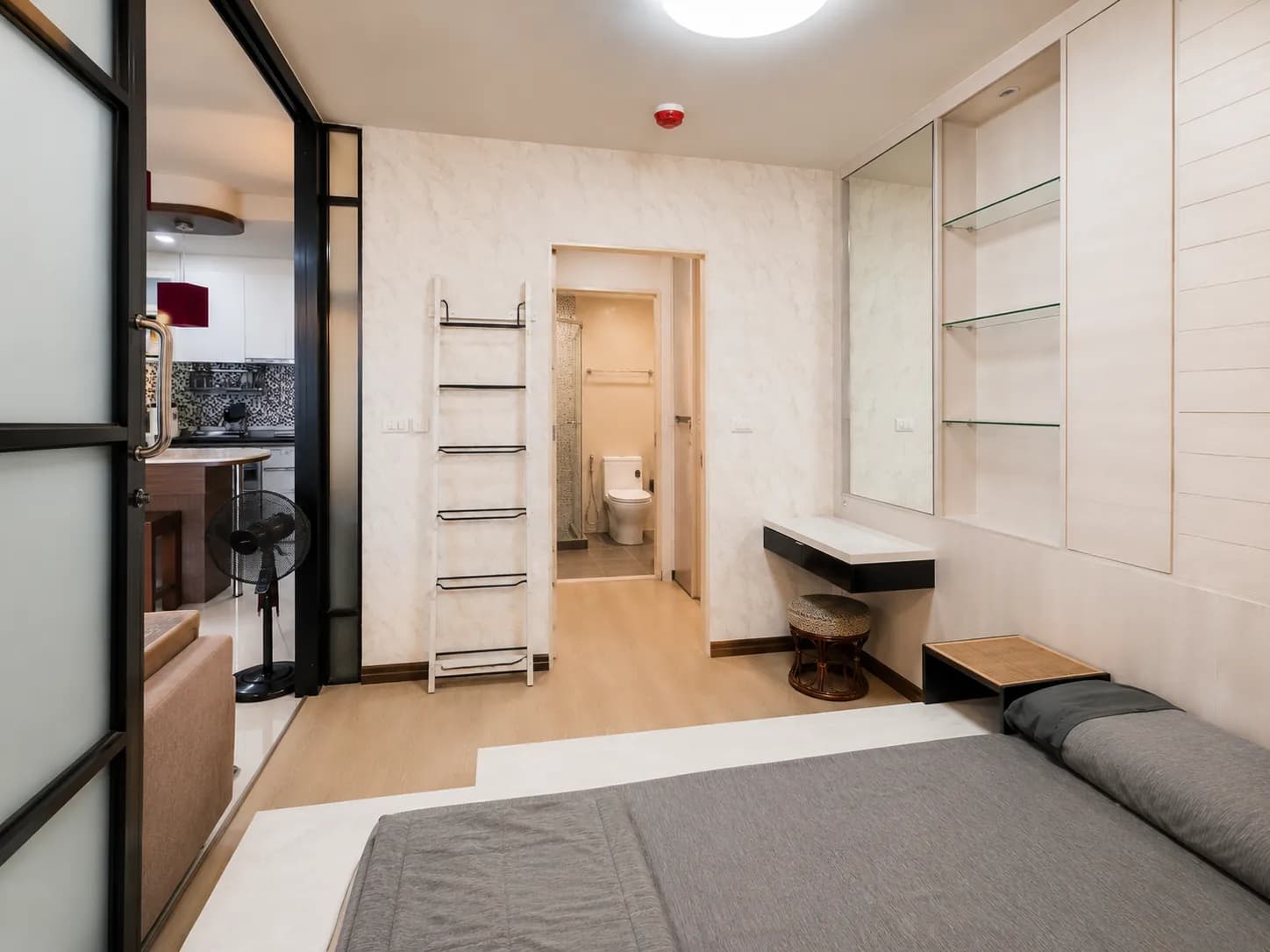 Furnished bedroom with built-in storage and ensuite bathroom access