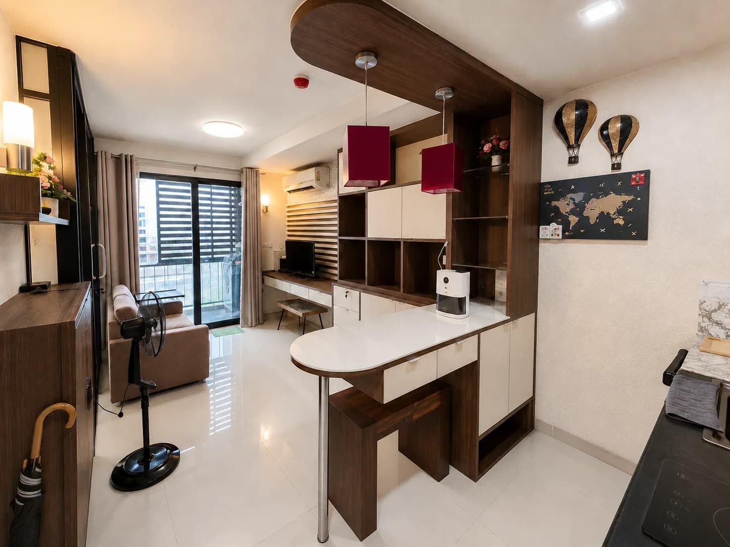 Modern living room with sofa, TV console, and balcony access